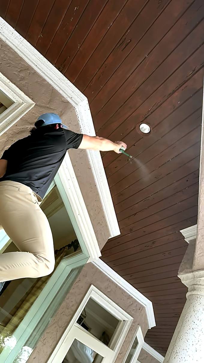 Technician spraying eaves and soffits